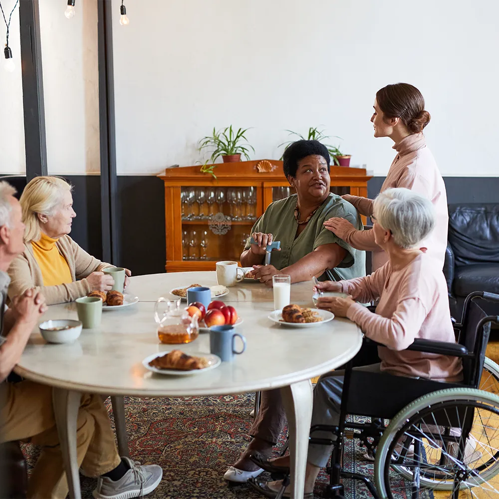 Elderly woman smiling during a senior day care art activity at Always Home Never Apart