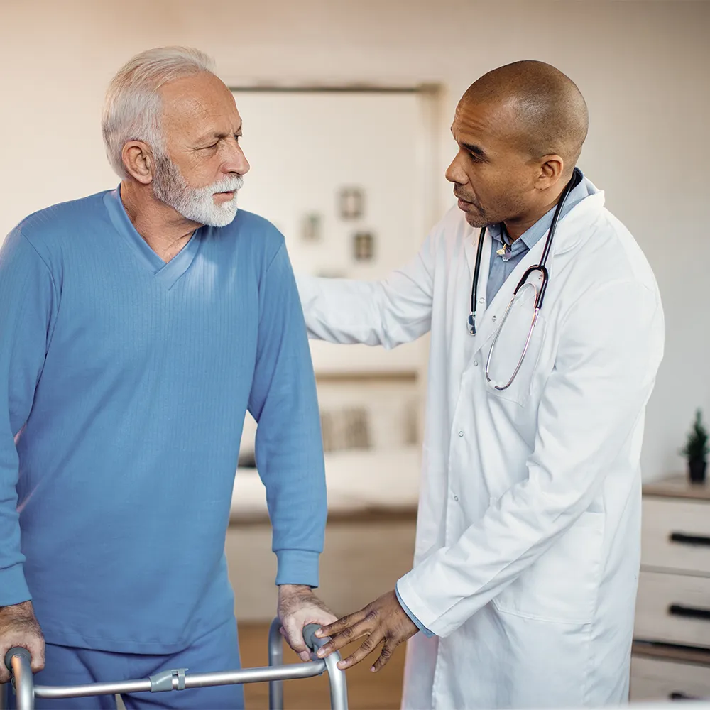 Caregiver assisting elderly patient with post surgery recovery at home in Trinidad